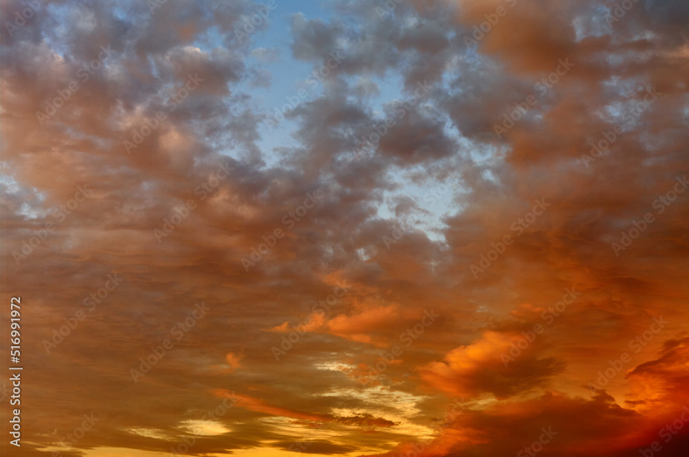 Sunset sky landscape, the sun painted the clouds in orange and red, dramatic sky, beautiful natural texture