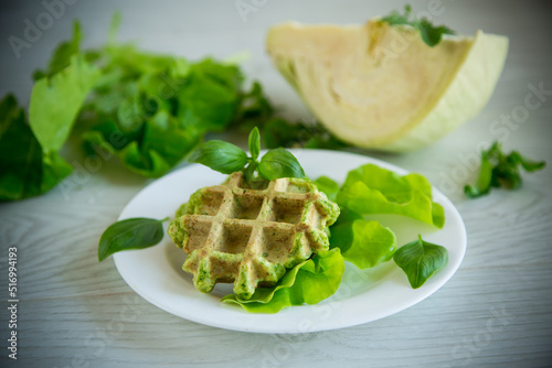 vegetable waffles cooked with herbs in a plate © Peredniankina