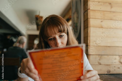 woman reading menu at restaurant