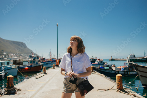 Young blonde woman exploring harbour photo