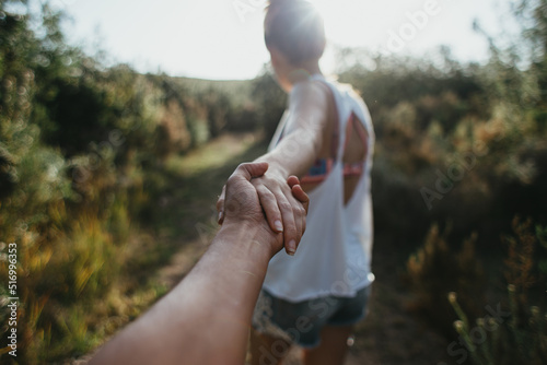 Young couple holding hands and leading