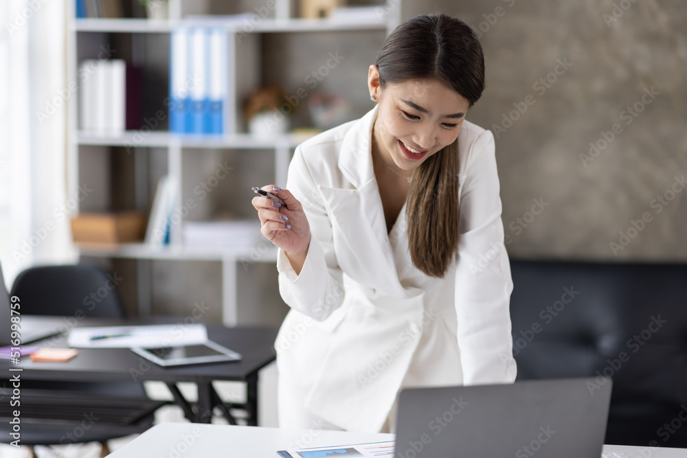 Young attractive business asian woman talking about sale report in video call conference on laptop computer online meeting in working from home office. Work remotely and Social isolation concept. Young attractive business asian woman talking about sale report in video call conference on laptop computer online meeting in working from home office. Work remotely and Social isolation concept.