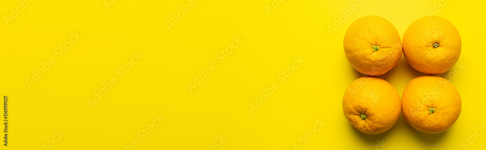 Flat lay with natural oranges on yellow background with copy space, banner. Flat lay with natural oranges on yellow background with copy space, banner.
