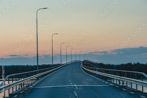 Highway bridge over a river in Sweden - a sunset sky in the background photo