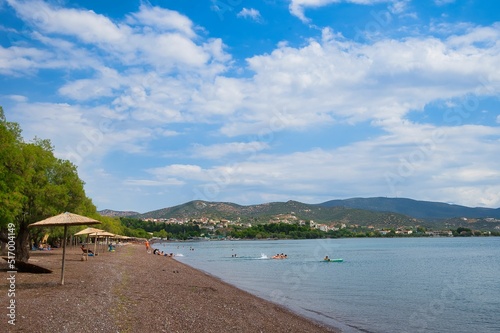 Anchialos town, Greece, wonderful beach with young people enjoying the sea photo