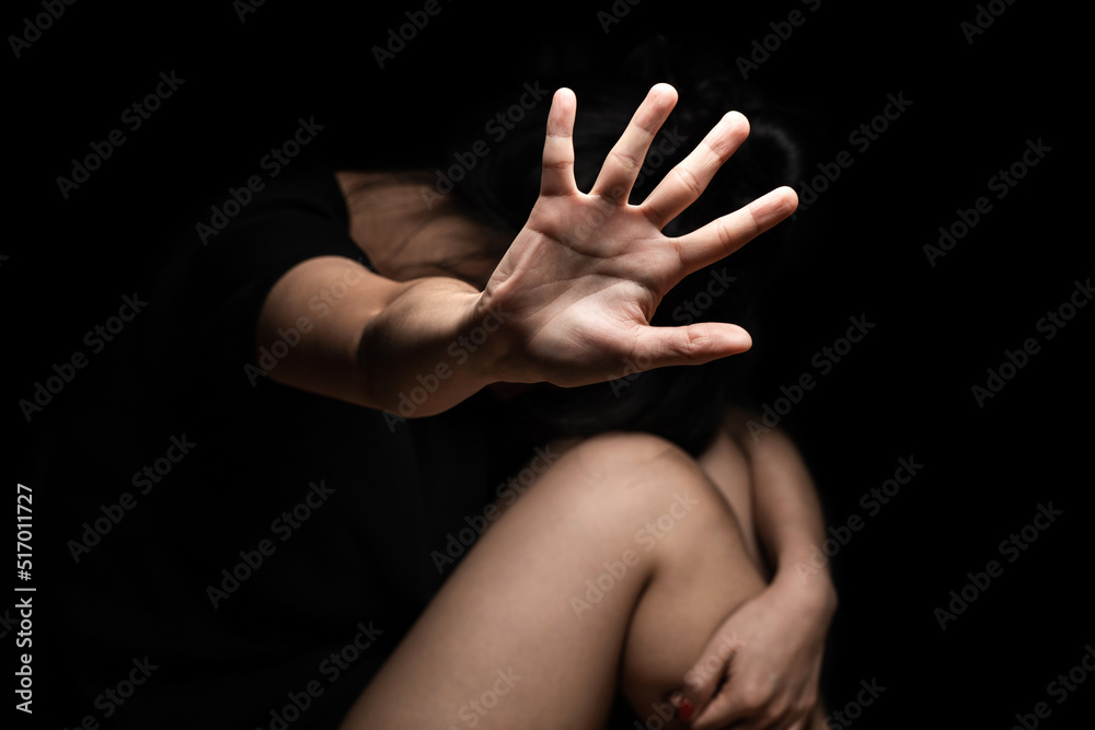 Fototapeta premium International Human Right day Concept: a girl with her hand extended signaling to stop