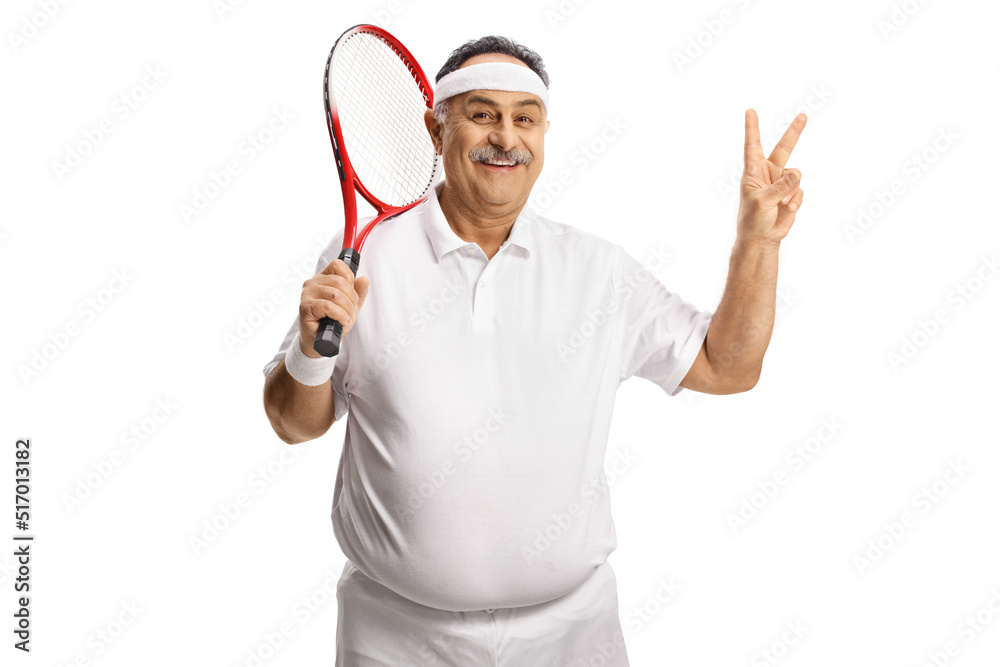 Happy mature man holding a tennis racket and gesturing victory sign Happy mature man holding a tennis racket and gesturing victory sign