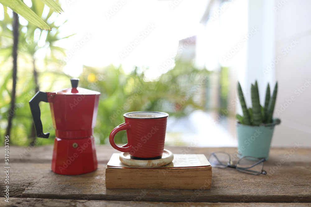 Red coffee cup and red moka pot and book and plant pot Red coffee cup and red moka pot and book and plant pot