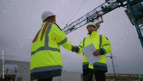 Wallpaper Mural female civil engineer and foreman are shaking hands in construction site, woman architect and builder Torontodigital.ca