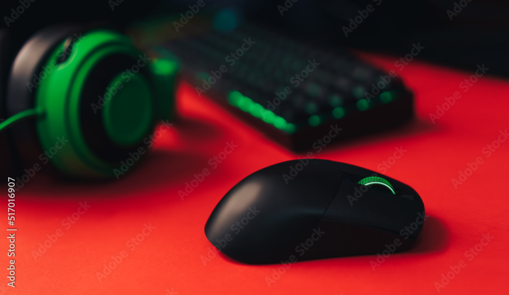 Computer gaming mouse and keyboard and green hedset on red background. Computer gaming mouse and keyboard and green hedset on red background.