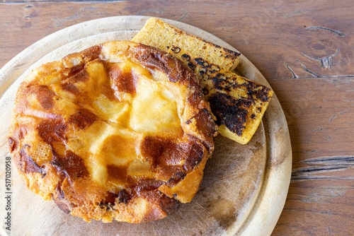 Closeup shot of traditional Frico with pan-fried cheese and potatoes photo