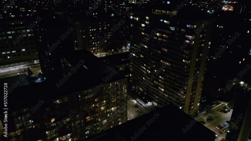 Aerial drone tilt down shot of multi storied office buildings in office area in Chicago, USA on a dark night. Aerial drone tilt down shot of multi storied office buildings in office area in Chicago, USA on a dark night.