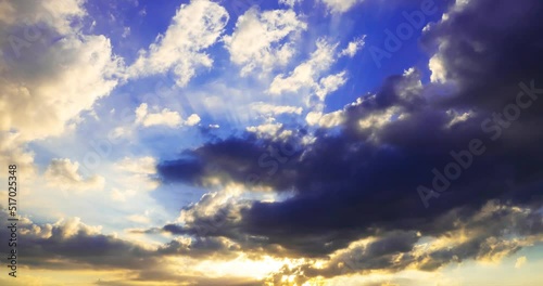 the sun's rays break through dark storm clouds