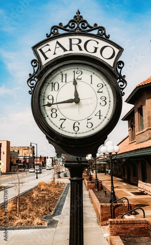 Vertical shot of a black vintage clock in Fargo, North Dakota at an old train depot photo