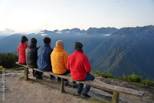 Trekkers in colorful jackets enjoying a mountain view in the Andes of Peru photo