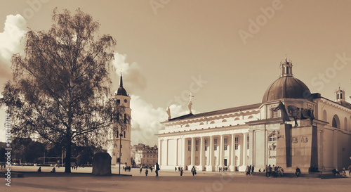 People walking in the main square of Lithuanian capital, Cathedral Square with Monument of Grand Duke Gediminas. photo