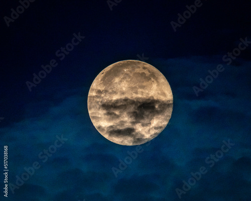 Los Angeles, CA, USA – July 14, 2022: A full moon starts its descent in the early morning hours above Los Angeles, CA.