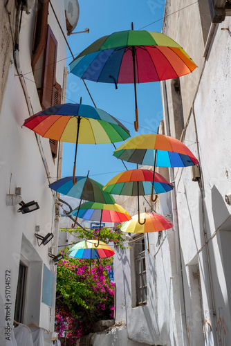 Bunte Schirme am Himmel in Gasse auf Naxos