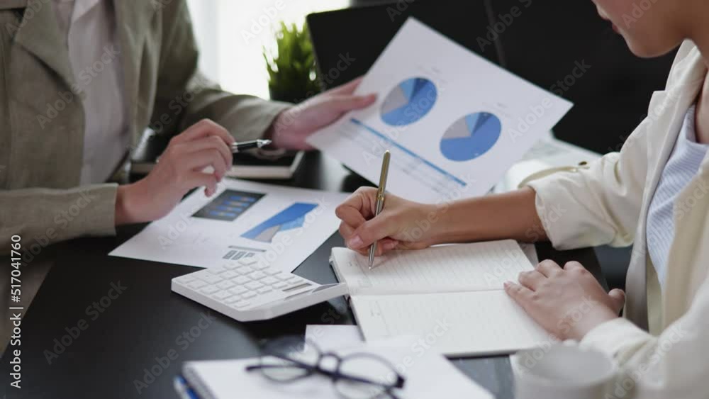 Business women are discussed and brainstorming on paperwork that show accounting numbers tables on office space. Business women are discussed and brainstorming on paperwork that show accounting numbers tables on office space.