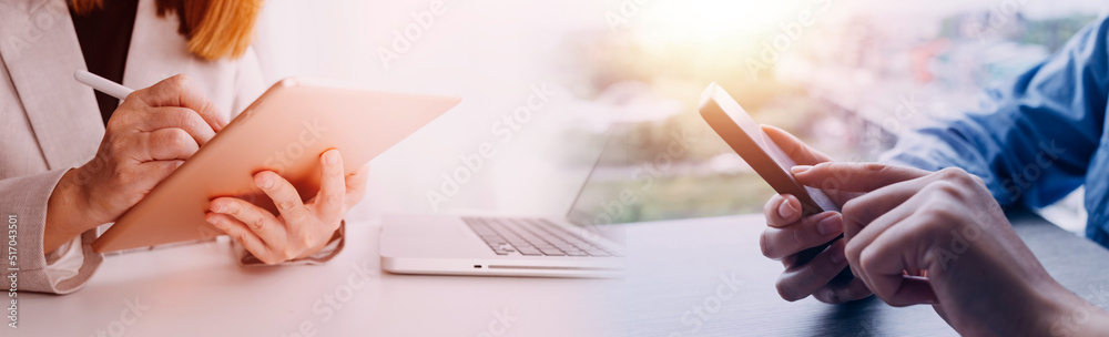 Business accountant working on desk using mobile phone and calculator to calculate budget concept finance and accounting in morning light