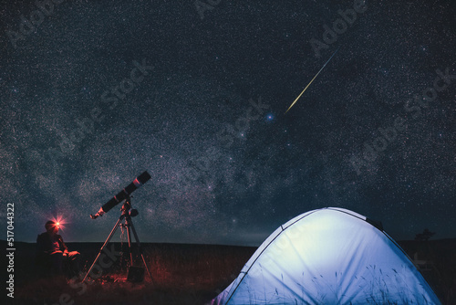 Fototapeta Amateur astronomer with astronomical telescope camping in nature under the Milky way stars