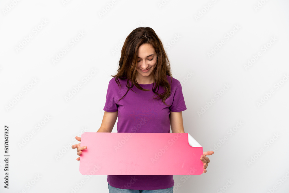 Young caucasian woman isolated on white background holding an empty placard Young caucasian woman isolated on white background holding an empty placard