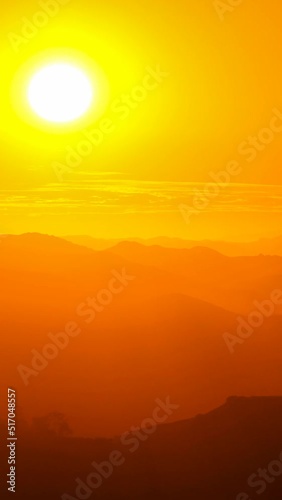 Vertical video of sun setting behind clouds above Simi Valley in Southern California.