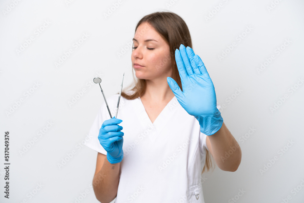 Dentist woman holding tools isolated on white background making stop gesture and disappointed Dentist woman holding tools isolated on white background making stop gesture and disappointed