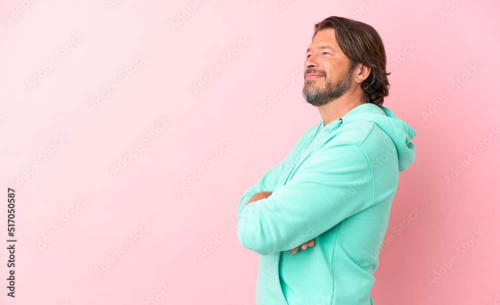 Senior dutch man isolated on pink background in lateral position Senior dutch man isolated on pink background in lateral position