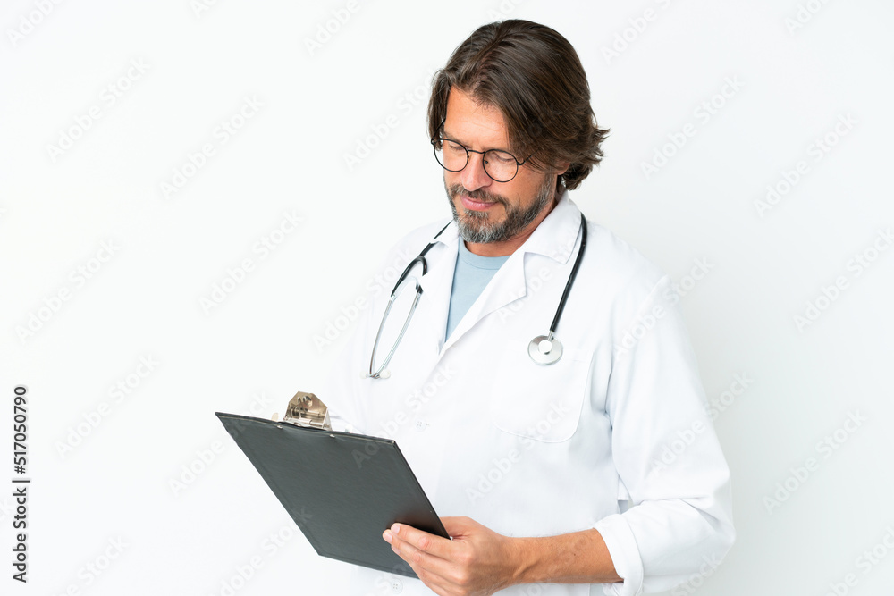 Senior dutch man isolated on white background wearing a doctor gown and holding a folder Senior dutch man isolated on white background wearing a doctor gown and holding a folder