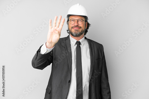 Young architect man with helmet over isolated background happy and counting four with fingers © luismolinero