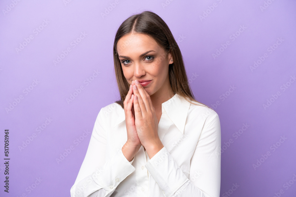 Young caucasian woman isolated on purple background keeps palm together. Person asks for something Young caucasian woman isolated on purple background keeps palm together. Person asks for something