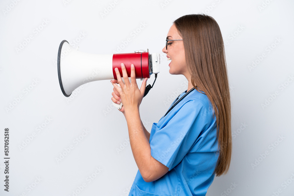 Young nurse caucasian woman isolated on white background shouting through a megaphone Young nurse caucasian woman isolated on white background shouting through a megaphone