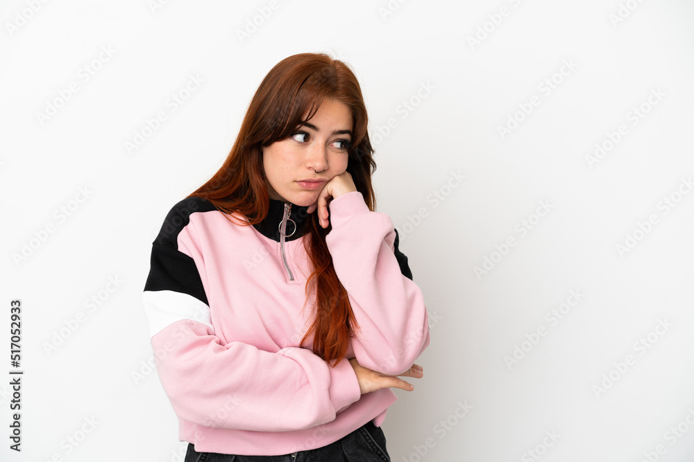 Young redhead woman isolated on white background with tired and bored expression Young redhead woman isolated on white background with tired and bored expression