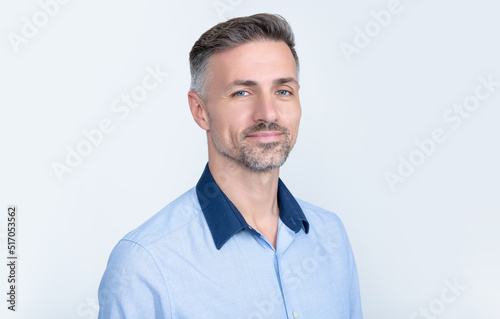 portrait of cheerful mature businessman in office shirt on grey background © be free