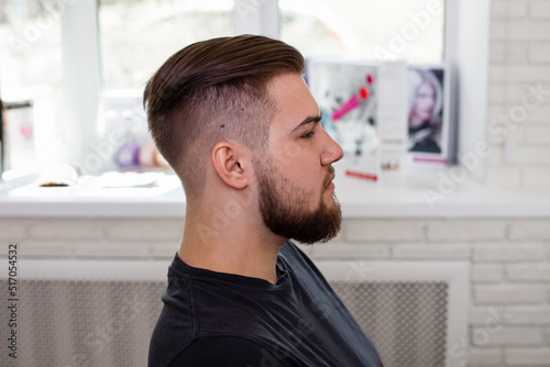  Brunette man with stylish haircut on barbershop background