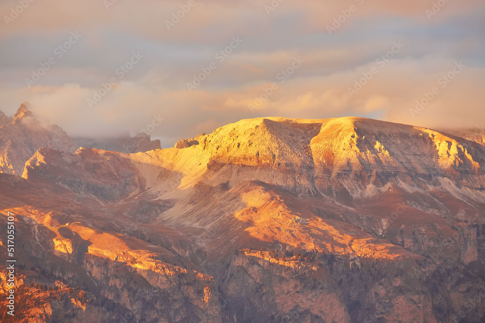 sunset over the Catinaccio group seen by Pozza di Fassa inside the Dolomite mountain range