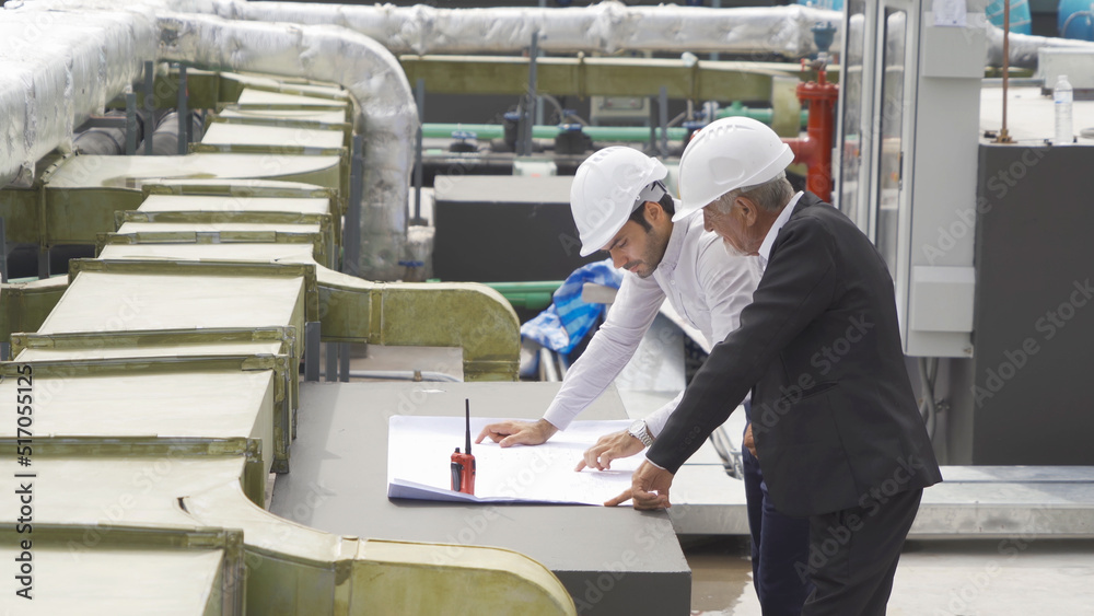 Engineer men or worker team, people working in industry factory. Chiller tower on rooftop building. System work machine. Condenser Water Supply pipe lines. Ventilation compressor Engineer men or worker team, people working in industry factory. Chiller tower on rooftop building. System work machine. Condenser Water Supply pipe lines. Ventilation compressor
