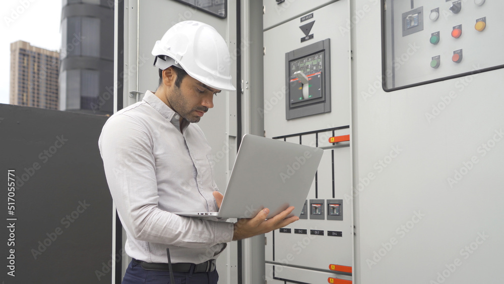 An engineer man or worker, people working in electrical room. Power energy motor machinery cabinets with panel in control or server room, operator station network in industry factory. Switchgear An engineer man or worker, people working in electrical room. Power energy motor machinery cabinets with panel in control or server room, operator station network in industry factory. Switchgear