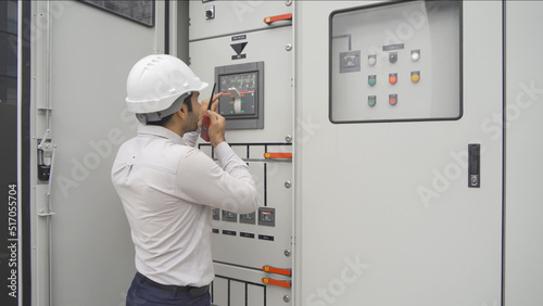 An engineer man or worker, people working in electrical room. Power energy motor machinery cabinets with panel in control or server room, operator station network in industry factory. Switchgear