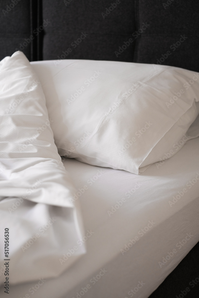 white pillow and blanket on the bed top view. bedding in a hotel room