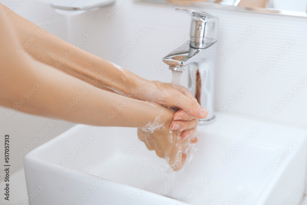 Washing hands under the flowing water tap. Washing hands rubbing with soap for corona virus prevention, hygiene to stop spreading corona virus in or public wash room. Hygiene concept hand detail Washing hands under the flowing water tap. Washing hands rubbing with soap for corona virus prevention, hygiene to stop spreading corona virus in or public wash room. Hygiene concept hand detail