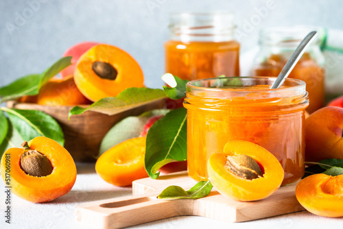 Obraz na plátne Apricot jam in glass jar, homemade preservation at white kitchen table