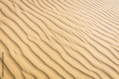 Clean pattern of fine sand on a sand beach