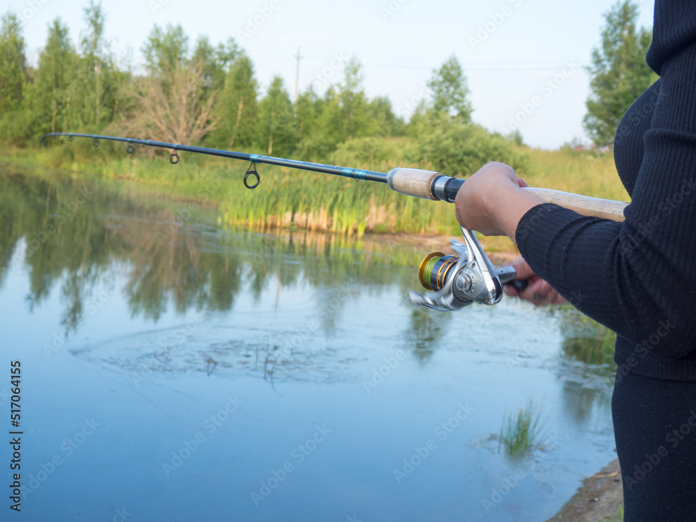girl catches fish on spinning on the lake girl catches fish on spinning on the lake