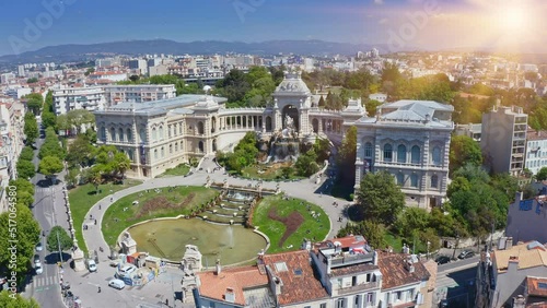 Longchamp palace park complex historical construction of classic architecture touristic place with fountain royal fortress in french town Marseille aerial panoramic view in sunlight from flying drone