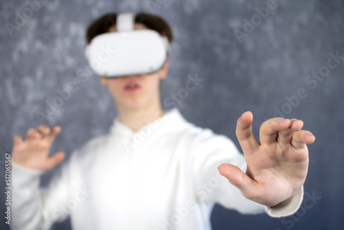 Amazed teenager using VR headset. Teen man play vr video game. Digital future and innovation. virtual goggles. Excited teen man with virtual reality goggles headset.