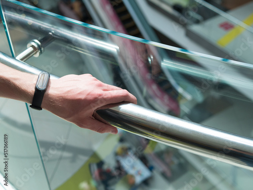 Canvastavla Man holding a hand rail in mall staircase closeup