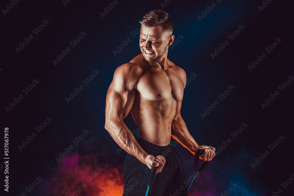 Muscular Athletic Men Exercise With Resistance Band. Copy Space