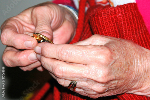 Female senior holding an antique heirloom in her hands.